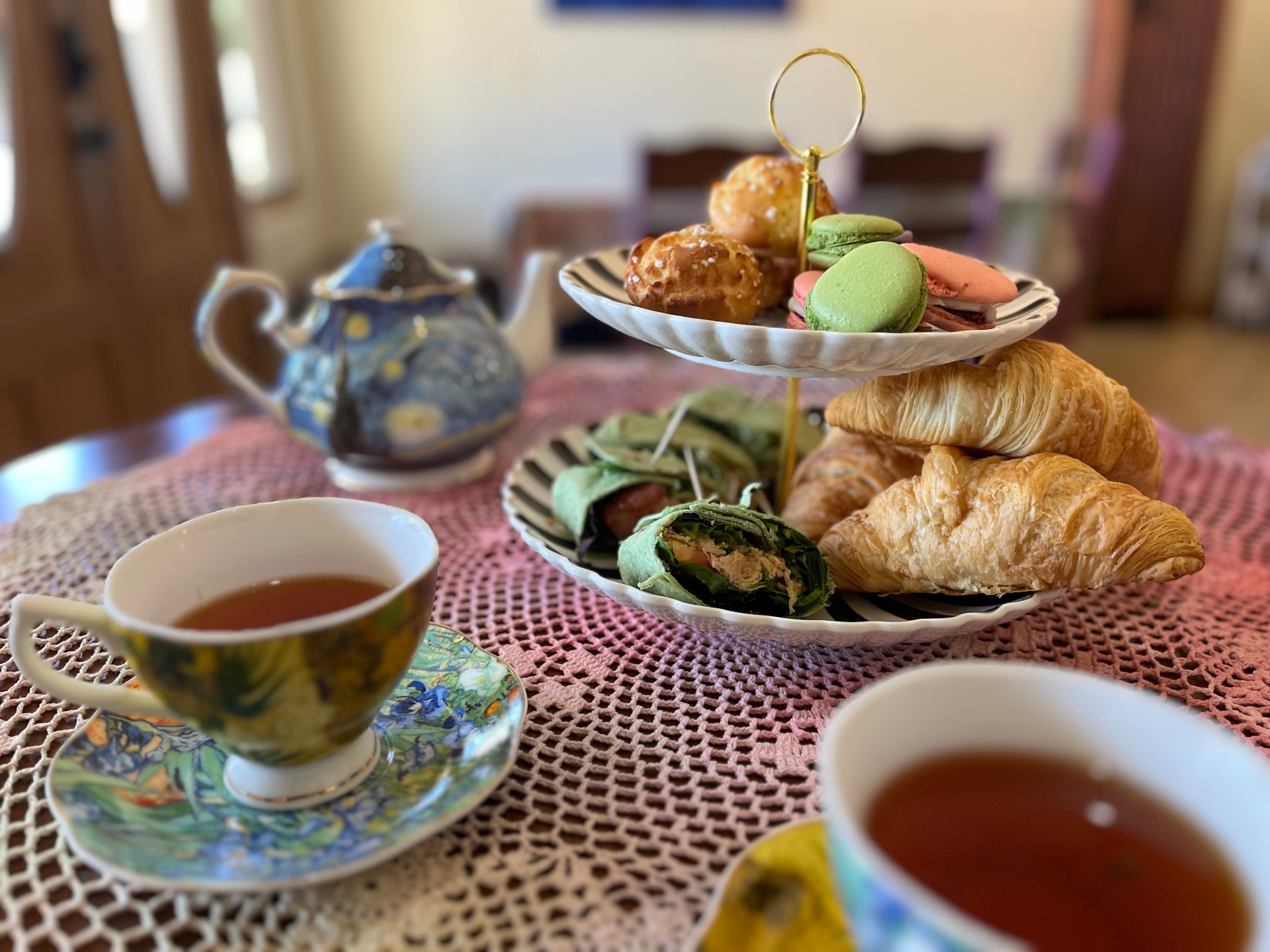 Teatime treats with tea, macarons, croissants, and a tiered stand at Rabbitbrush Studio